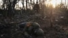 A Ukrainian soldier passes by the body of a dead Russian soldier at the front line a few kilometers from Andriyivka on September 16.