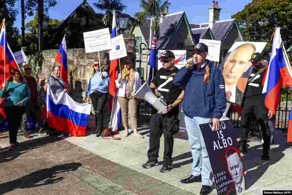 Pro-Kremlin protesters wave Russian flags outside the official residence of Australia's Prime Minister Anthony Albanese in Sydney on June 24 amid the standoff over the embassy site. Canberra claimed the land-lease cancellation was due to issues of national security. The Kremlin called the move "another step by Anthony Albanese toward a deliberate and systematic destruction of relations with Moscow." 