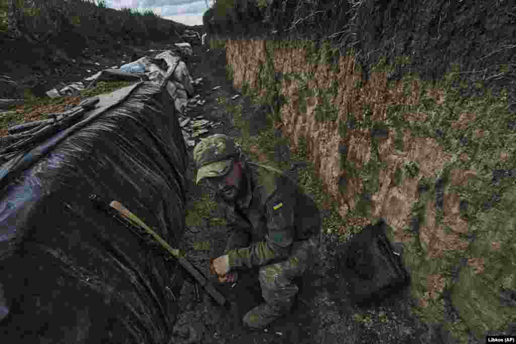 A Ukrainian soldier sits in a trench at the front line near Bakhmut on May 22. Two days earlier, the chief of Russia's Wagner mercenary group, Yevgeny Prigozhin, claimed his troops had taken control of the city.