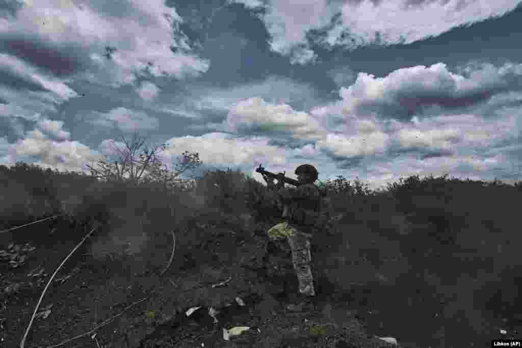 A Ukrainian soldier fires an RPG toward enemy positions from his trench. Moscow says capturing Bakhmut opens the way to further advances in the eastern industrial Donbas region bordering Russia. Kyiv says its advance on the Russian forces' flanks is more meaningful than its withdrawal inside Bakhmut itself, and Russia will have to weaken its lines elsewhere to send reinforcements to hold the shattered city.