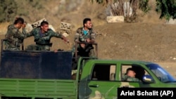 Syrian soldiers at the Quneitra border crossing between Syria and the Israeli-controlled Golan Heights on July 26, 2018.