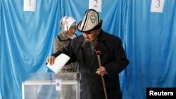 Kazakhs vote during snap parliamentary elections in the southern village of Toretam on March 20.