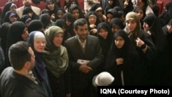 Ikballe Huduti-Berisha (in green head scarf) stands next to former Iranian President Mahmud Ahmadinehad in an undated photo.