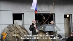 Protest Leader Brandishes AK-47 At Pro-Russian Rally In Luhansk