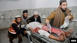A man injured in a bomb blast at an Islamic center in Peshawar is rushed to a local hospital on January 16. 