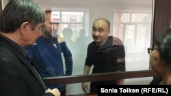 Kazakh activists Maks Boqaev (2nd right) and Talgat Ayan (2nd left) appear in court in Atyrau on November 18.