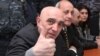 Armenia - Hovannes Tamamian, a police general arrested in March 2011, gestures to a photojournalist at the start of his trial in Yerevan, 16Feb2012.
