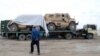 Trucks transporting NATO military vehicles destined for the Pakistani port city of Karachi cross into Pakistan near the Afghan border in Chaman on November 25.