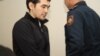Sayan Khayrov (left) appears in Kazakh court on October 16