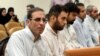 Vahid Mazloumin (left) appears in court in Tehran on charges of manipulating the currency market on September 8.