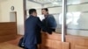 Amin Eleusinov (right) was released on parole after being sentenced to two years in prison in May 2017. (file photo)