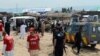 Pakistani security and medical personnel are pictured at the site of a car-bomb attack at the Jalozai refugee camp near Peshawar on March 21.