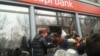 The tenge's devaluation has triggered a series of public protests in Almaty, as well as a bank run by panicked savers on three private banks on February 18.