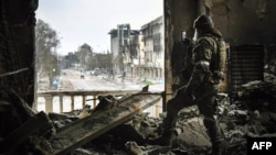 Російський військовий в розбомбленому Маріуполі, місцевий драмтеатр, 2022 рік 