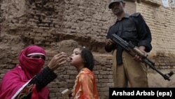 A polio worker administers a polio vaccine to a child in Peshawar. Pakistan is one of a handful of countries where the disease is still endemic. 