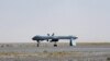 A U.S. Predator unmanned drone armed with a missile stands on the tarmac of the Kandahar military airport in Afghanistan.