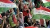 Supporters of opposition cleric Tahirul Qadri listen to him speaking during protests in Islamabad on August 19. 
