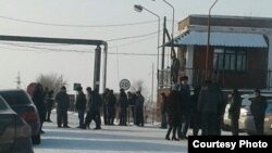 Miners and their relatives gather at the entrance to a mine in Kazakhstan's Qaraghandy region where workers have gone on strike. 