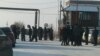 Miners and their relatives gather at the entrance to a mine in Kazakhstan's Qaraghandy region where workers have gone on strike.