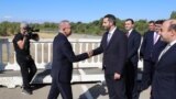 Armenia/Turkey - Armenian parliament vice-speaker Ruben Rubinian (right) greets Turkish envoy Serdar Kilic on a Turkish-Armenian border bridge, September 12, 2025.