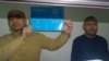 Max Boqaev (left) and Talghat Ayan in an Atyrau courtroom on October 18. 