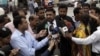 Prosecutor Chaudhry Zulfikar (center) talking to journalists outside a court in Rawalpindi on April 26.