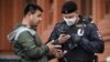 A man shows his digital ID to a Russian police officer amid a coronavirus lockdown on May 6. 
