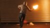 A man throws a Molotov cocktail (illustrative photo)