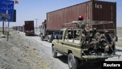 Pakistani paramilitary soldiers escort a convoy of trucks, carrying supplies for NATO troops in Afghanistan, before crossing into Afghanistan from the Pakistan border town of Chaman. (file photo)