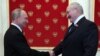 Russian President Vladimir Putin (left) and Belarusian President Alyaksandr Lukashenka shake hands during a ceremony at the Kremlin in Moscow on June 24.