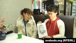 Daichi Yoshida's mother, Yoko Yoshida (left), and his brother Seyja Yoshida look at a portrait of Daichi drawn by Seyja during a prison visit.