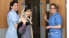 Pakistani schoolgirl Malala Yousafzai (center) waves with nurses as she is discharged from the Queen Elizabeth Hospital in Birmingham.