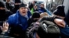 Kazakh police detain a participant in an opposition rally in Almaty on February 28. Human rights groups have said Kazakhstan’s law on public gatherings violates international standards.