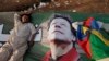 Supporters of Imran Khan, the head of the Pakistan Tehrik-e Insaf political party, take a nap on Khan's campaign banner during what has been dubbed a "freedom march" in Islamabad on August 25.