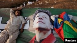Supporters of Imran Khan, the head of the Pakistan Tehrik-e Insaf political party, take a nap on Khan's campaign banner during what has been dubbed a "freedom march" in Islamabad on August 25.