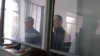 Uali Aliasqarov (left) and Mikhail Tkachyov in court in Qaraghandy on November 21. 