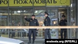 Belarusian police in a cordoned-off area at the Minsk shopping center where the deadly incident took place 