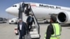 Passengers disembark an Iranian Mahan Air flight at the airport in Kabul on September 15.