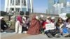 Some of those demonstrating at the Baitarek in downtown Astana on May 27 in favor of government intervention amid mounting foreclosures.
