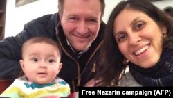 Nazanin Zaghari-Ratcliffe (right) poses for a photograph with her husband, Richard, and daughter, Gabriella.
